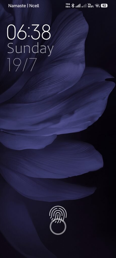 Lock screen with a purple feather wallpaper, large clock and fingerprint graphic.